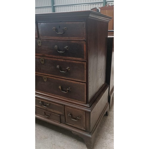 205 - A late 18th century oak and walnut crossbanded chest on stand, with two short and three long drawers... 