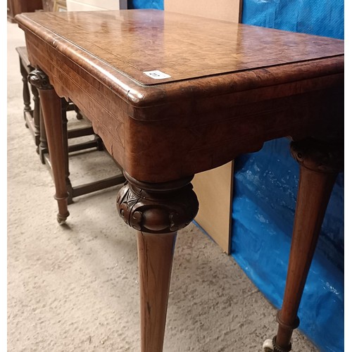 217 - A Victorian walnut folding card table, on turned tapering legs to castors, 90 cm widePlease note col... 