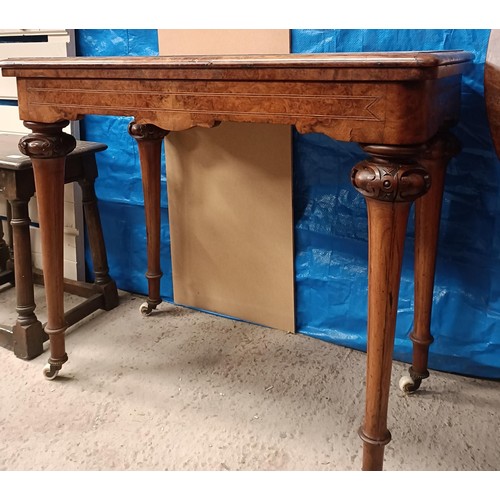 217 - A Victorian walnut folding card table, on turned tapering legs to castors, 90 cm widePlease note col... 