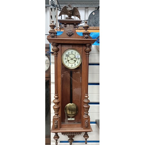 209 - A Vienna regulator style clock, in a walnut case with an eagle finial, 130 cm highPlease note collec... 