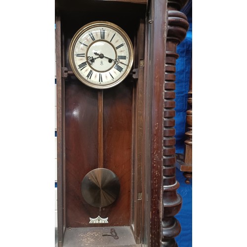 210 - A Vienna regulator style clock, the enamel dial initialled GB, in a walnut case with an eagle finial... 