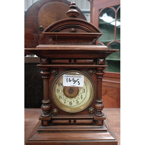 166 - A mantle clock, with a twin train eight day movement striking on a bell, in a polished slate case, 3... 