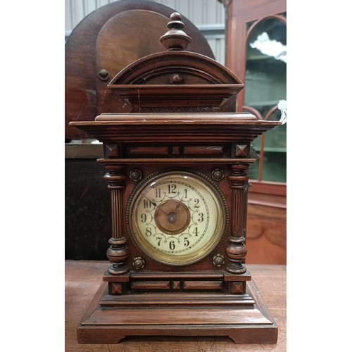 166 - A mantle clock, with a twin train eight day movement striking on a bell, in a polished slate case, 3... 