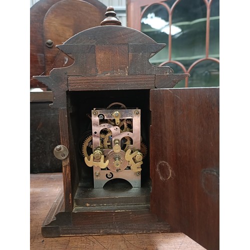 166 - A mantle clock, with a twin train eight day movement striking on a bell, in a polished slate case, 3... 