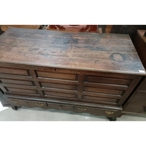 165 - An 18th century oak mule chest, with a hinged top, on a base with three drawers, 146 cm widePlease n... 