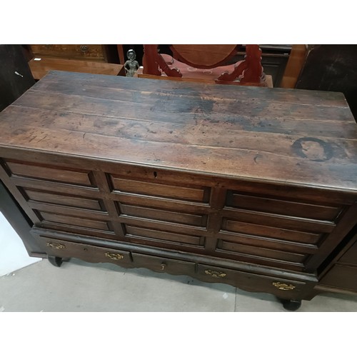 165 - An 18th century oak mule chest, with a hinged top, on a base with three drawers, 146 cm widePlease n... 