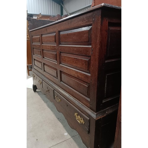 165 - An 18th century oak mule chest, with a hinged top, on a base with three drawers, 146 cm widePlease n... 