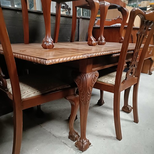 175 - A set of four mahogany Chippendale style dining chairs, with a matching draw leaf table, 150 cm wide... 