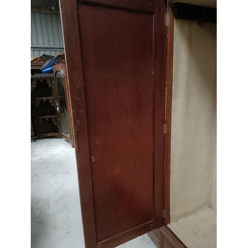 207 - A mahogany wardrobe, with two cupboard doors, a drawer on the base, 124 cm widePlease note collectio... 