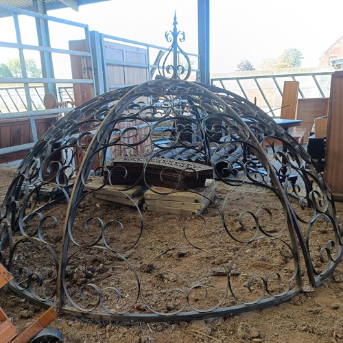 392 - A wrought iron garden Gazebo the supports in the from of columns, approx. 8ft diameter, unassembled,... 