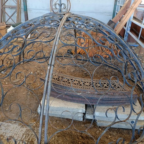 392 - A wrought iron garden Gazebo the supports in the from of columns, approx. 8ft diameter, unassembled,... 