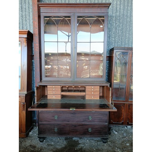 77 - A George III mahogany secretaire bookcase, the top with two glazed doors, above a fitted drawer, and... 