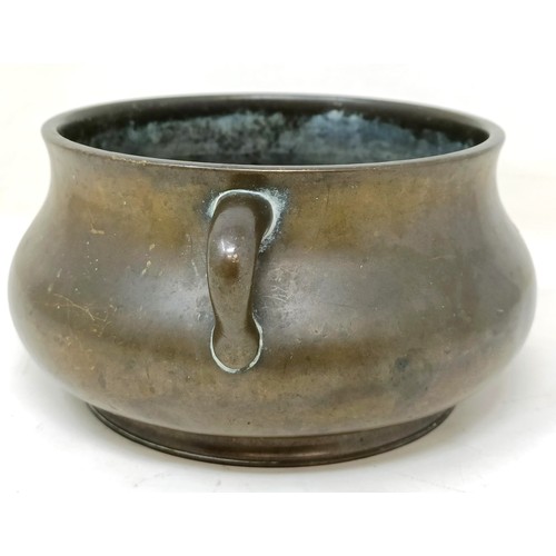 803 - A Chinese bronze censer, of compressed circular form and with twin handles, character mark to base, ... 