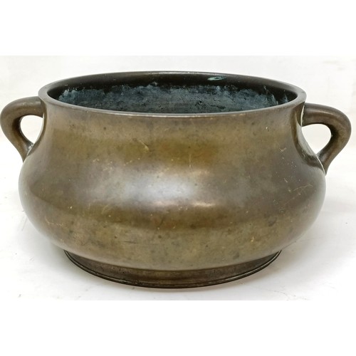 803 - A Chinese bronze censer, of compressed circular form and with twin handles, character mark to base, ... 