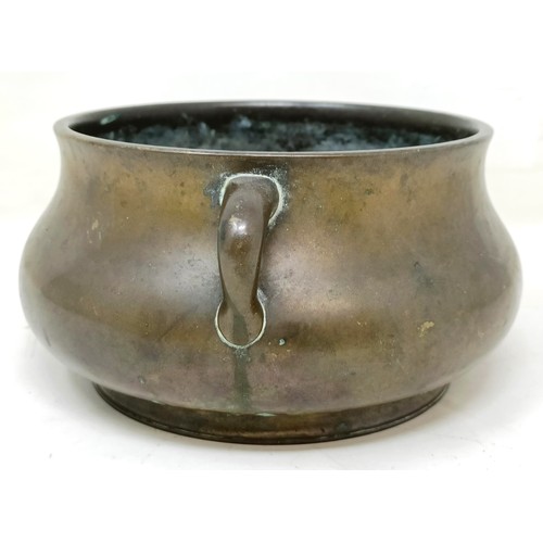 803 - A Chinese bronze censer, of compressed circular form and with twin handles, character mark to base, ... 