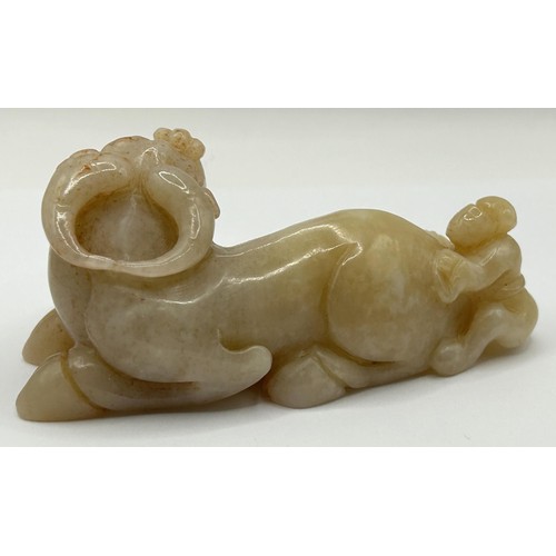 814 - A Chinese carved pale stone figure of an ox and a man, 9 cm wide