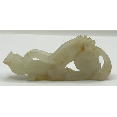 816 - A Chinese carved pale stone figure of a dragon, 8 cm wide