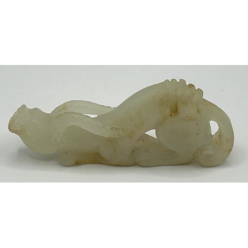 816 - A Chinese carved pale stone figure of a dragon, 8 cm wide