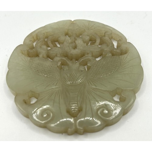 817 - A Chinese pale hardstone pierced plaque, decorated butterflies, 6 cm diameter