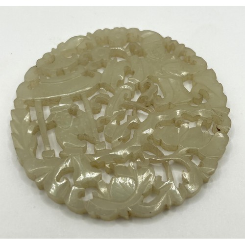 822 - A Chinese pale hardstone pierced plaque, 6 cm diameter