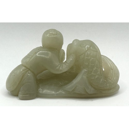 825 - A Chinese carved green stone figure of a man with a fish, 8 cm wide