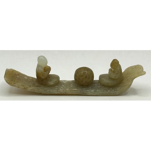 827 - A Chinese carved green stone figure on a boat, 8 cm wide