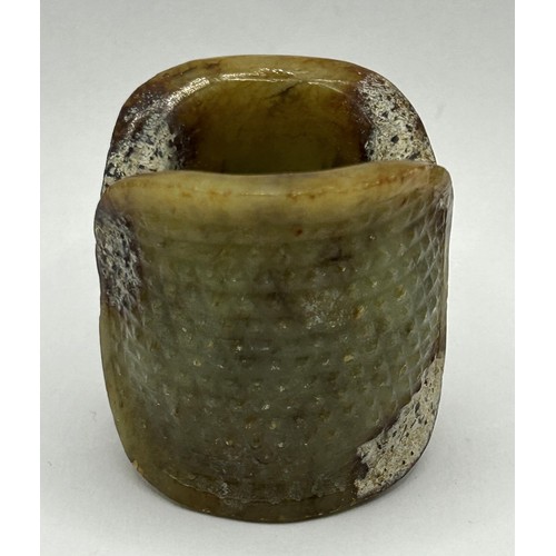 828 - A Chinese carved green stone ring, 4 cm wide