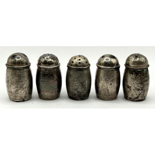 854 - A set of five Chinese silver coloured metal pepper pots, a baby's rattle, and a weight