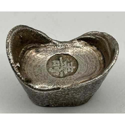 854 - A set of five Chinese silver coloured metal pepper pots, a baby's rattle, and a weight