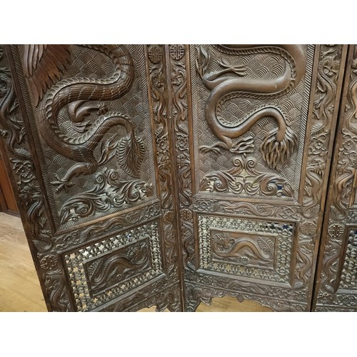 878 - A Chinese carved four fold screen, decorated dragons and flowers, each panel 190 cm high x 50 cm wid... 