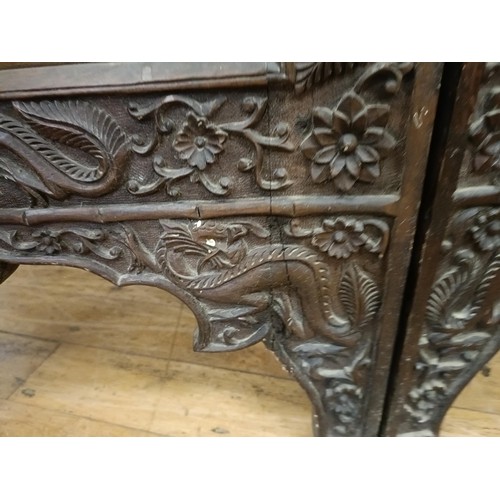 878 - A Chinese carved four fold screen, decorated dragons and flowers, each panel 190 cm high x 50 cm wid... 