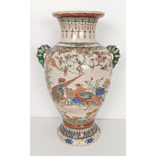 909 - A Japanese pottery vase, decorated a peacock and pheasants, 37 cm high