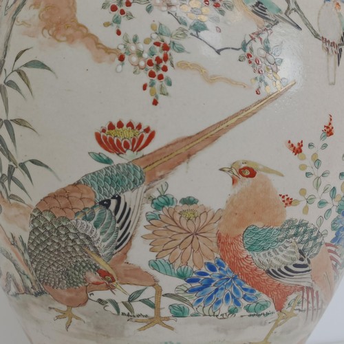 909 - A Japanese pottery vase, decorated a peacock and pheasants, 37 cm high