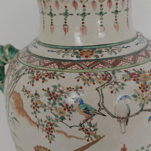 909 - A Japanese pottery vase, decorated a peacock and pheasants, 37 cm high