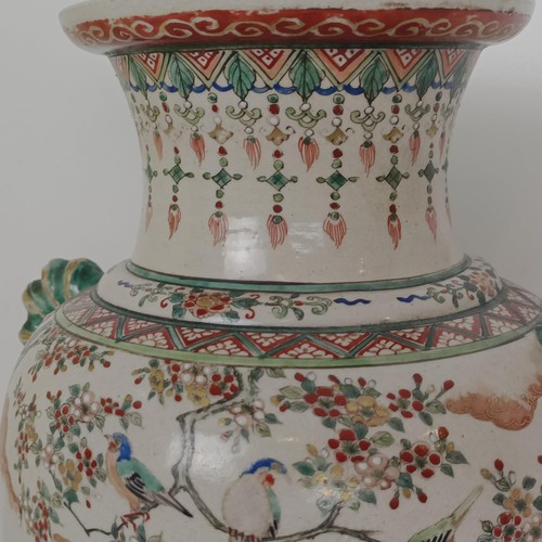 909 - A Japanese pottery vase, decorated a peacock and pheasants, 37 cm high