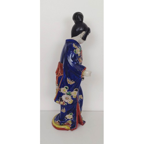 910 - A Japanese figure of a lady, 43 cm high