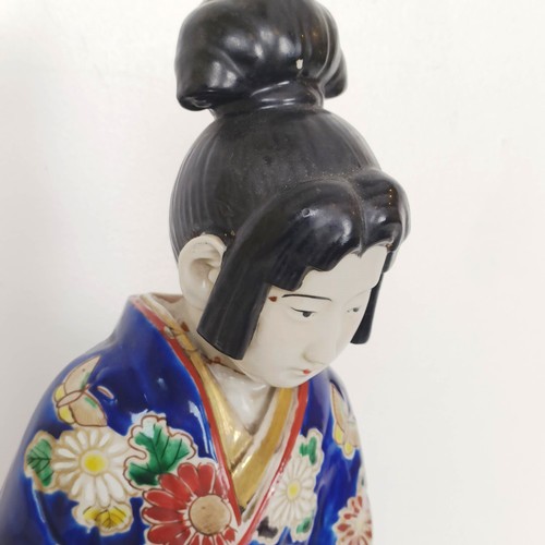 910 - A Japanese figure of a lady, 43 cm high