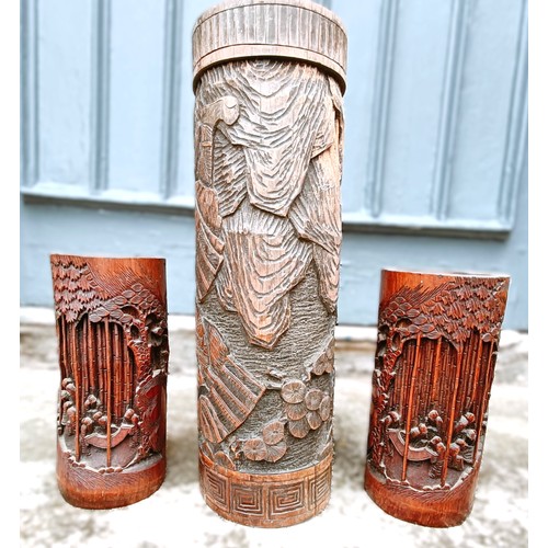 923 - A pair of Chinese carved bamboo brush stands, 25 cm high, and another, 46 cm high (3)