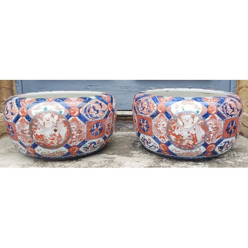 930 - A large pair of Japanese Imari planters, with various cartouches decorated figures, character mark t... 