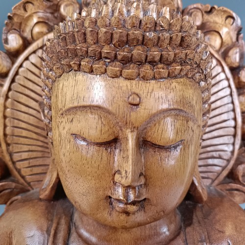 931 - A large carved wooden Buddha, 53 cm high