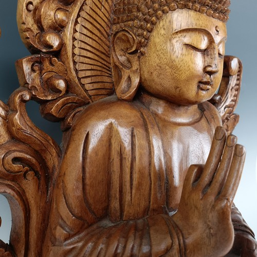 931 - A large carved wooden Buddha, 53 cm high