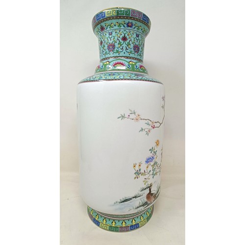 942 - A Chinese famille rose vase, of cylindrical form, decorated a peacock, character mark to base, 43 cm... 