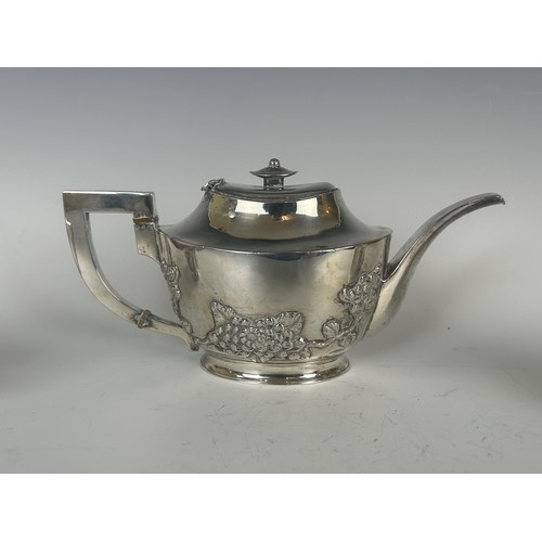 846 - A Chinese silver coloured metal three piece tea set, decorated blossom (3)