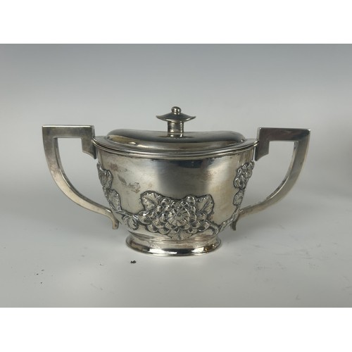 846 - A Chinese silver coloured metal three piece tea set, decorated blossom (3)