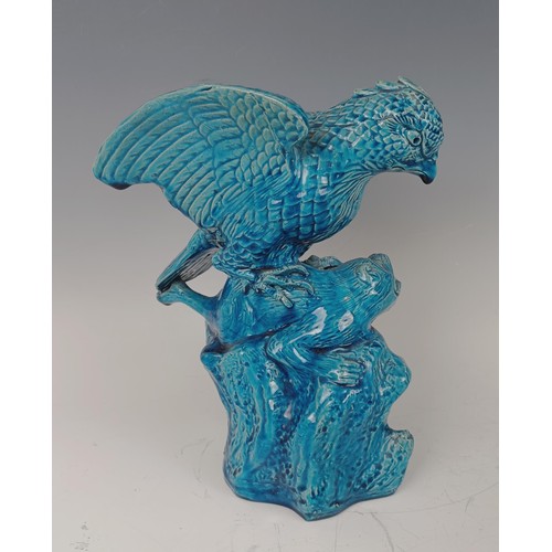 948 - A Chinese turquoise glazed figure of a bird attacking a beast, 26 cm high