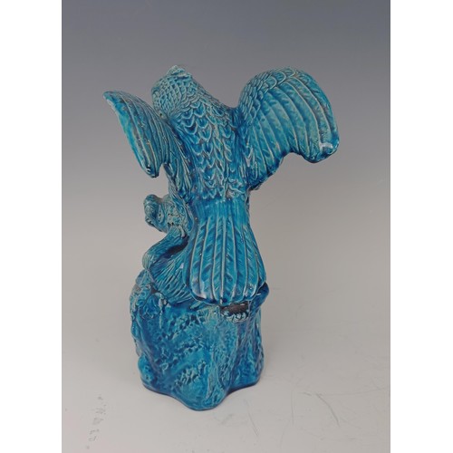 948 - A Chinese turquoise glazed figure of a bird attacking a beast, 26 cm high