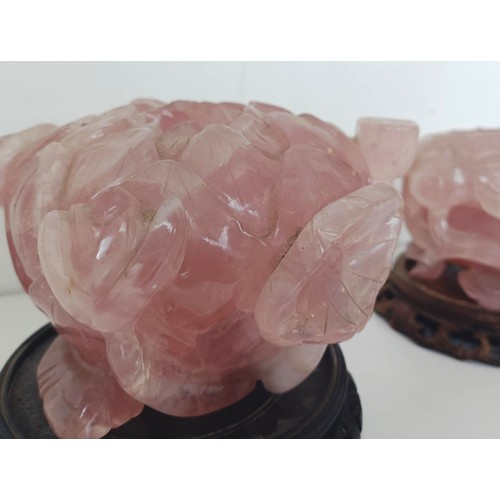 957 - A Chinese rose quartz carved bowl, in the form of a flower, with a hardwood base, 10 cm diameter and... 