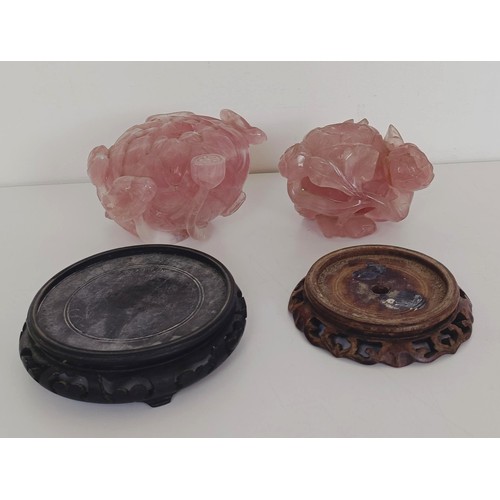 957 - A Chinese rose quartz carved bowl, in the form of a flower, with a hardwood base, 10 cm diameter and... 