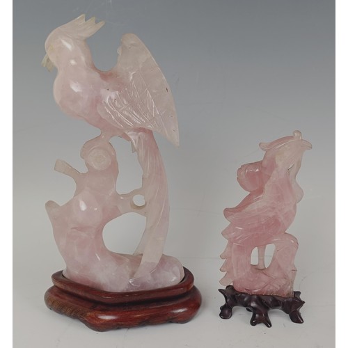 959 - A Chinese rose quartz carving of a bird, on a wooden base, 20 cm high, and another similar, 13 cm hi... 