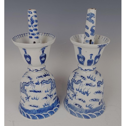 964 - A pair of Chinese blue and white oil lamps, decorated dragons chasing a flaming pearl in underglaze ... 